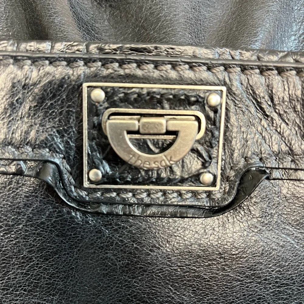 The Sak Expandable Black Leather Suede Shoulder Tote Bag with Suede Tassels